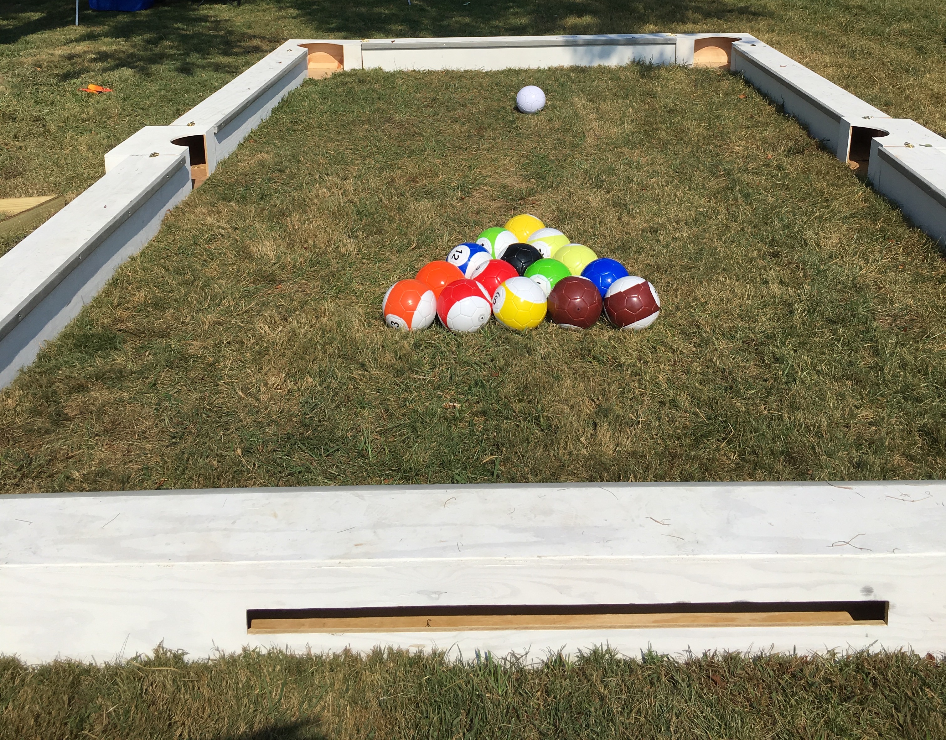 Soccer billiards set up on grass