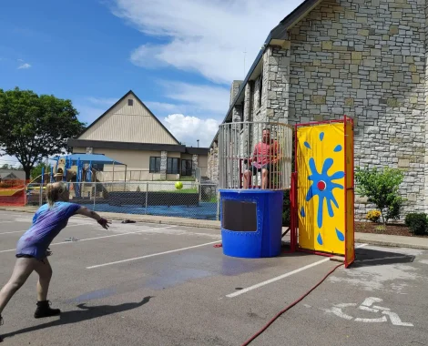 Girl throwing ball at a dunk tank